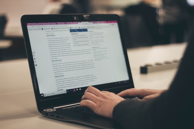 a person typing on a laptop